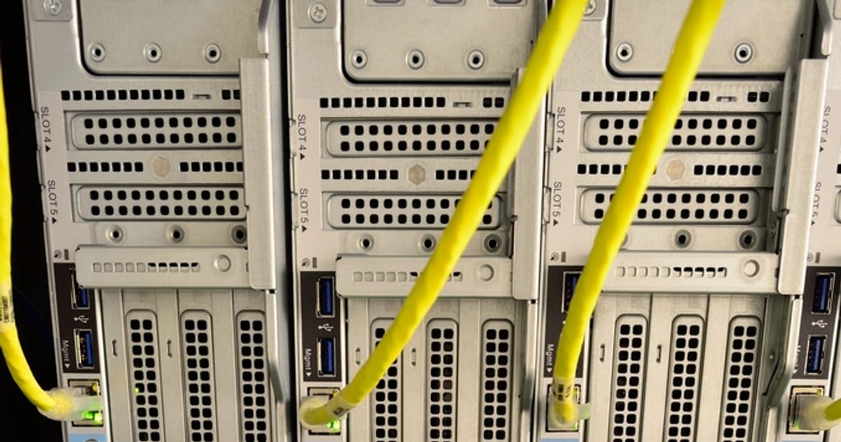 Close-up of server blades with network patch cables in a data center